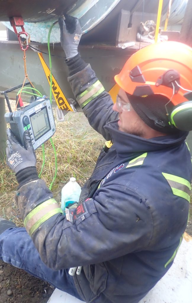 Brent Moulton performing ultrasonic corrosion mapping on Pipeline in Alaska oil field.